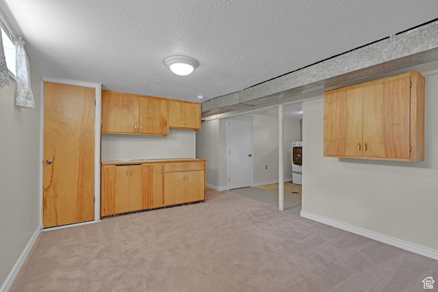 2458 N 575 E, North Ogden, UT 84414 - kitchen with light carpet, a textured ceiling, baseboards, light countertops, and light brown cabinets