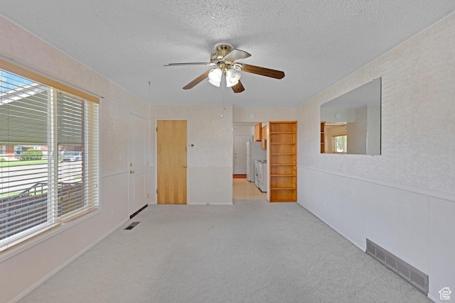 2458 N 575 E, North Ogden, UT 84414 - empty room featuring ceiling fan, healthy amount of natural light, a textured ceiling, and light carpet
