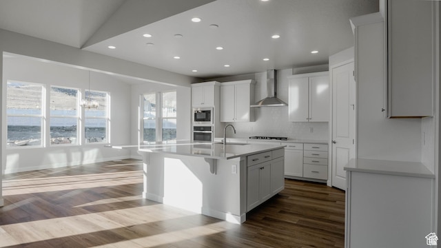 877 W Sika Cir S Unit 203, Saratoga Springs, UT 84045 - kitchen featuring wall chimney range hood, appliances with stainless steel finishes, recessed lighting, decorative backsplash, and dark wood-style floors