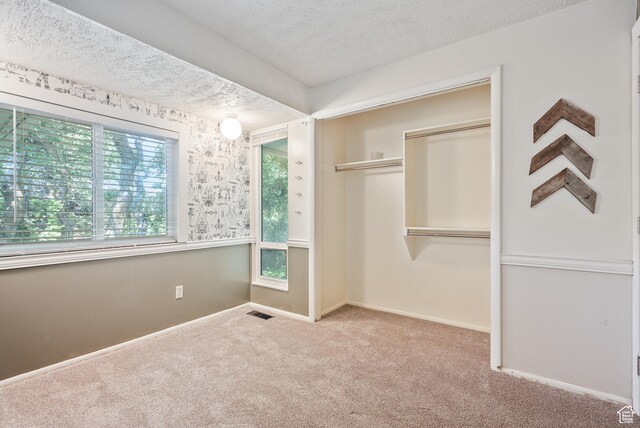 153 W 4350 N, Pleasant View, UT 84414 - unfurnished bedroom featuring carpet flooring, a closet, baseboards, and a textured ceiling