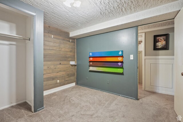 153 W 4350 N, Pleasant View, UT 84414 - carpeted bedroom with wood walls, a textured ceiling, and baseboards