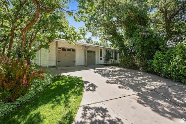 153 W 4350 N, Pleasant View, UT 84414 - view of front of home with brick siding, concrete driveway, and an attached garage
