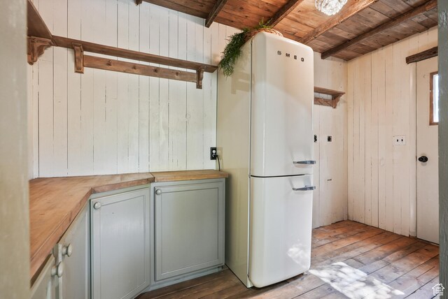 153 W 4350 N, Pleasant View, UT 84414 - kitchen with butcher block counters, freestanding refrigerator, wood ceiling with exposed beams, wood-type flooring, and wooden walls