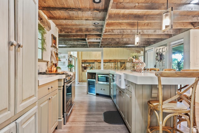153 W 4350 N, Pleasant View, UT 84414 - kitchen featuring wooden ceiling with exposed beams, stainless steel appliances, wood finished floors, light countertops, and a sink
