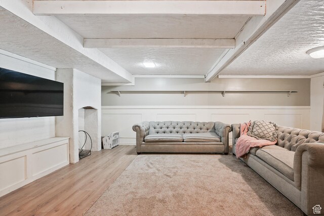 153 W 4350 N, Pleasant View, UT 84414 - living room featuring light wood-type flooring, a decorative wall, and a wainscoted wall