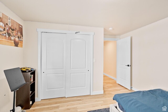 12568 S Bridal Veil Dr W, Riverton, UT 84065 - bedroom with light wood-style flooring, a closet, and baseboards