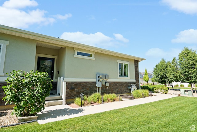 12568 S Bridal Veil Dr W, Riverton, UT 84065 - back of property featuring stucco siding, stone siding, and a lawn