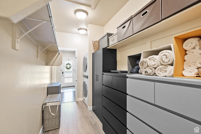 12568 S Bridal Veil Dr W, Riverton, UT 84065 - walk in closet with stacked washing machine and dryer and light wood-style floors