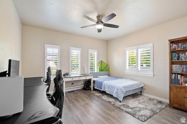 12568 S Bridal Veil Dr W, Riverton, UT 84065 - bedroom featuring wood finished floors, a desk, baseboards, and ceiling fan