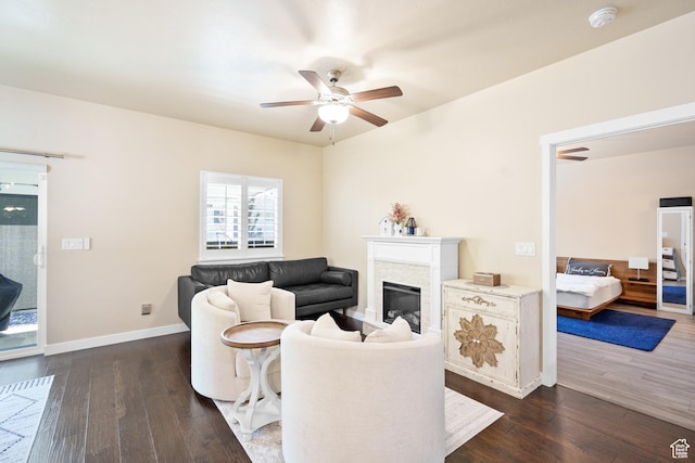 12568 S Bridal Veil Dr W, Riverton, UT 84065 - living room with a ceiling fan, dark wood-style flooring, a glass covered fireplace, and baseboards