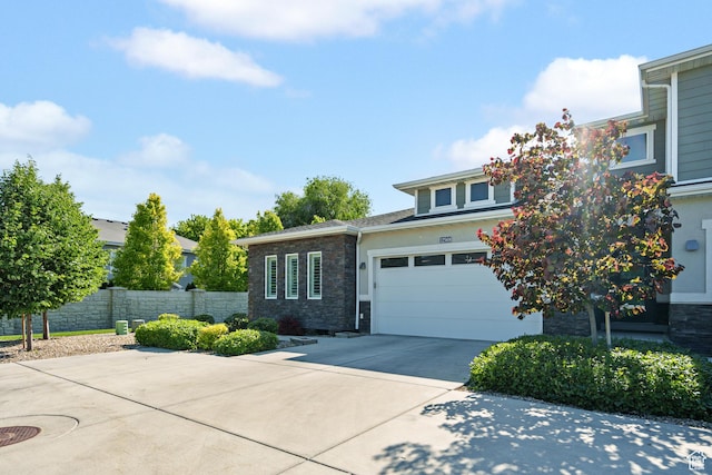 12568 S Bridal Veil Dr W, Riverton, UT 84065 - view of front facade featuring driveway, stone siding, stucco siding, and an attached garage