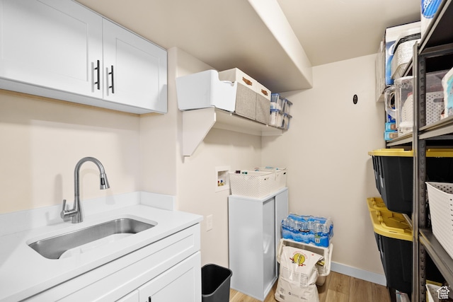 12568 S Bridal Veil Dr W, Riverton, UT 84065 - laundry room with washer hookup, cabinet space, light wood-style floors, and baseboards