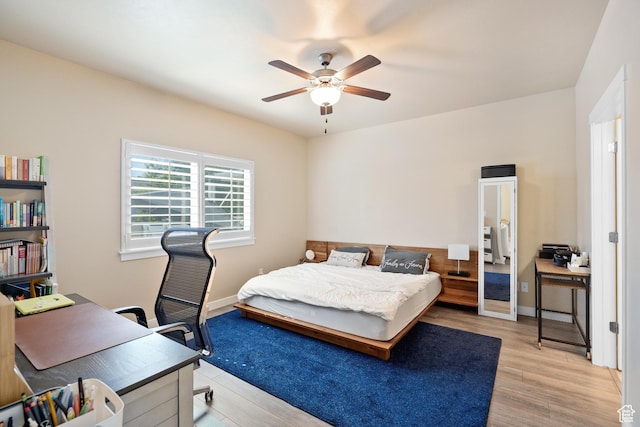 12568 S Bridal Veil Dr W, Riverton, UT 84065 - bedroom featuring light wood-style floors, a ceiling fan, baseboards, and a desk