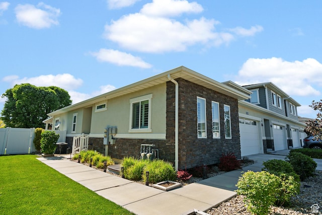 12568 S Bridal Veil Dr W, Riverton, UT 84065 - view of front of home with stone siding, stucco siding, an attached garage, and driveway