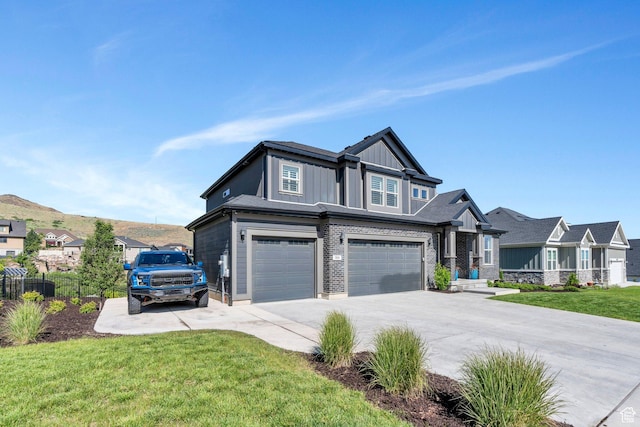 15058 S Spring Canyon Dr, Herriman, UT 84096 - view of front of home featuring a garage, concrete driveway, board and batten siding, a front yard, and a residential view