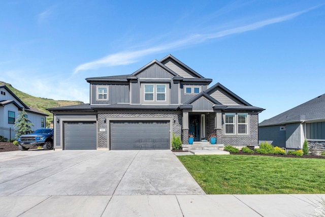 15058 S Spring Canyon Dr, Herriman, UT 84096 - view of front of property featuring board and batten siding, a front lawn, an attached garage, driveway, and brick siding