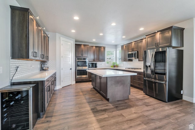 15058 S Spring Canyon Dr, Herriman, UT 84096 - kitchen featuring appliances with stainless steel finishes, wine cooler, recessed lighting, light countertops, and tasteful backsplash