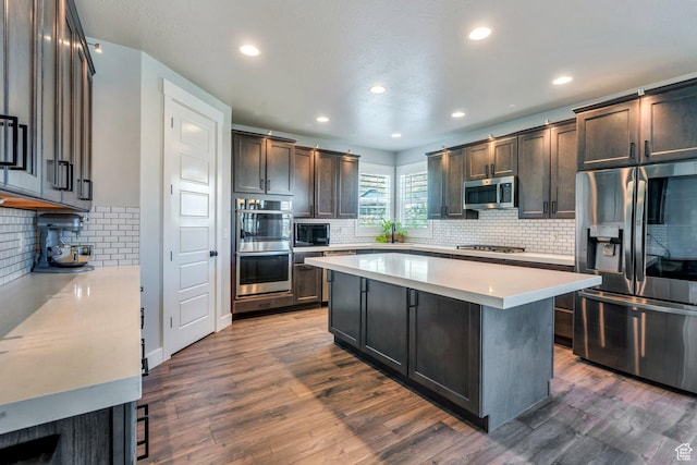 15058 S Spring Canyon Dr, Herriman, UT 84096 - kitchen featuring appliances with stainless steel finishes, backsplash, light countertops, recessed lighting, and dark wood finished floors