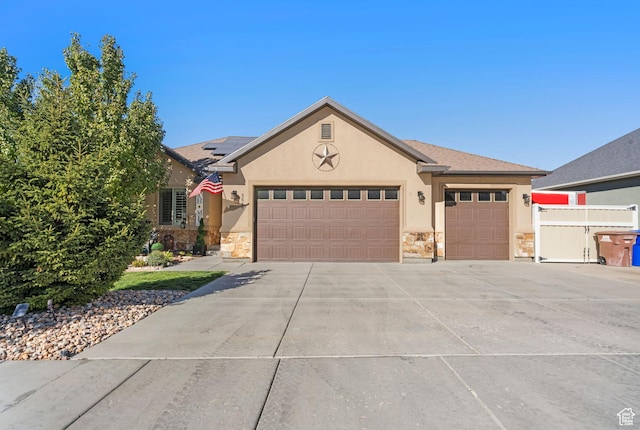 3547 E Jacobs Way, Eagle Mountain, UT 84005 - ranch-style house with stone siding, stucco siding, an attached garage, and roof mounted solar panels