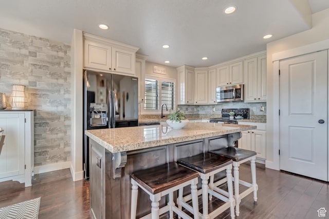 3547 E Jacobs Way, Eagle Mountain, UT 84005 - kitchen with stainless steel microwave, baseboards, black range with electric cooktop, dark wood-type flooring, and light stone countertops