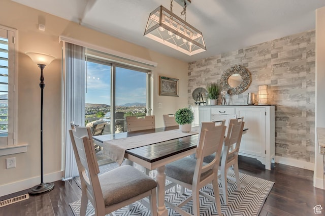 3547 E Jacobs Way, Eagle Mountain, UT 84005 - dining space with an accent wall, baseboards, healthy amount of natural light, and dark wood-style floors