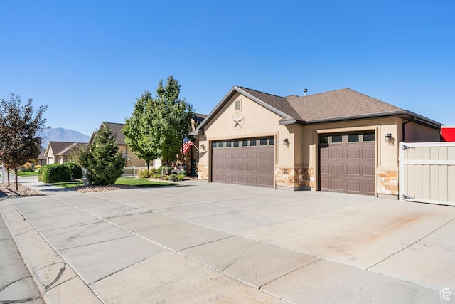3547 E Jacobs Way, Eagle Mountain, UT 84005 - view of front of home featuring stucco siding, an attached garage, driveway, stone siding, and roof with shingles