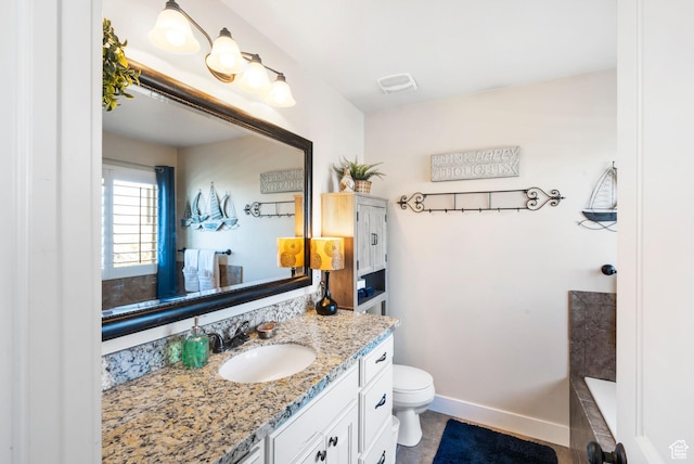 3547 E Jacobs Way, Eagle Mountain, UT 84005 - bathroom with vanity, toilet, a bath, and baseboards
