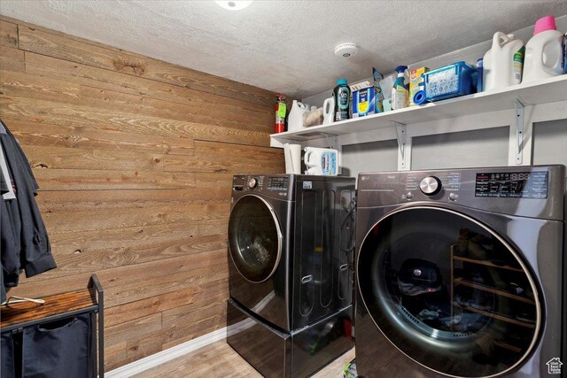 1602 E 2550 N, Layton, UT 84040 - washroom featuring washer and clothes dryer, wood walls, a textured ceiling, wood finished floors, and baseboards