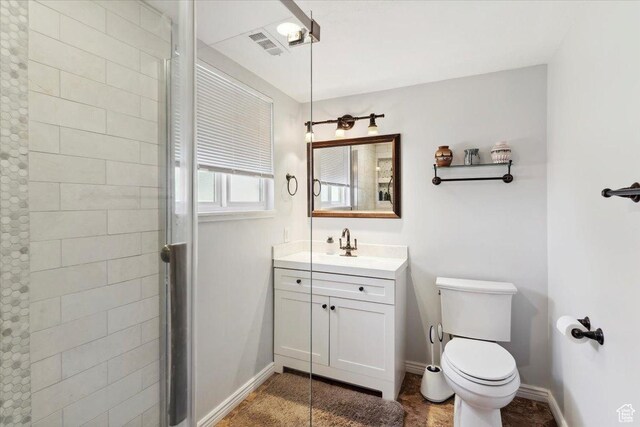 1602 E 2550 N, Layton, UT 84040 - bathroom with toilet, vanity, baseboards, and tiled shower