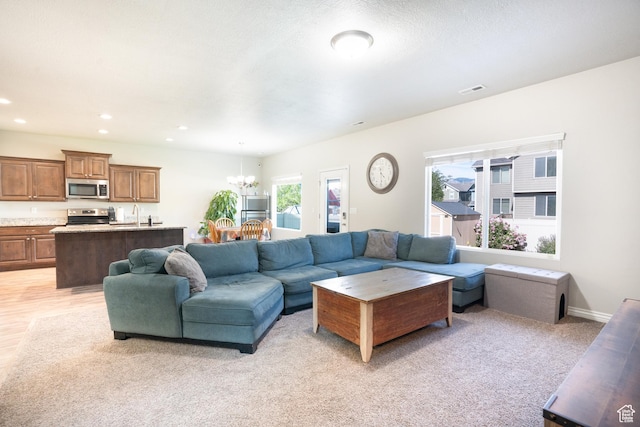 2534 S 2200 W, West Haven, UT 84401 - living area featuring a chandelier, recessed lighting, and light carpet