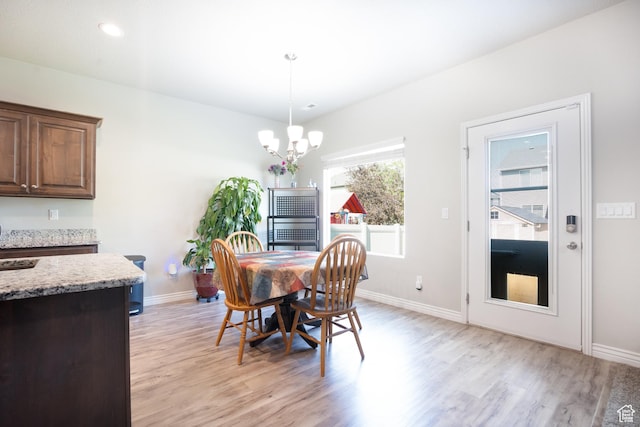 2534 S 2200 W, West Haven, UT 84401 - dining space featuring light wood finished floors, a chandelier, and baseboards