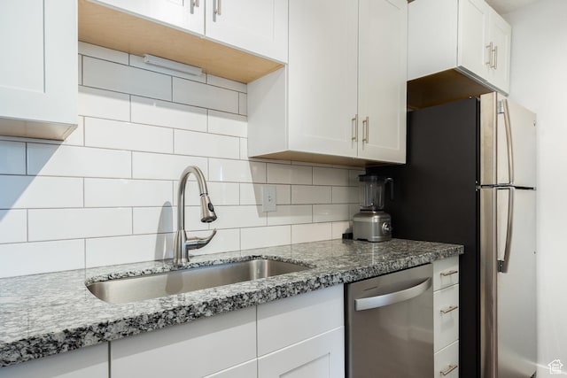 123 E 2nd Ave N Unit 1211, Salt Lake City, UT 84103 - kitchen featuring stainless steel appliances, a sink, white cabinetry, and backsplash