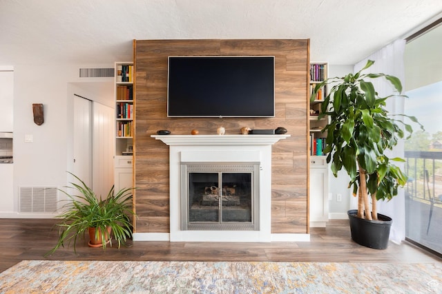 123 E 2nd Ave N Unit 1211, Salt Lake City, UT 84103 - living area featuring wood finished floors, a fireplace, a textured ceiling, and baseboards