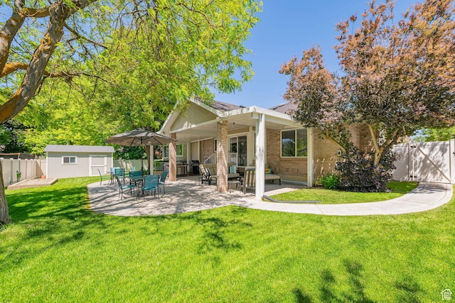 2678 E 25 S, Layton, UT 84040 - back of property featuring brick siding, a patio, a fenced backyard, and a storage shed