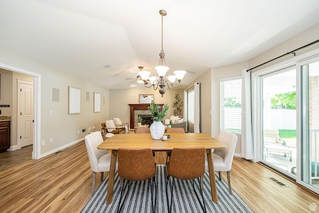 2678 E 25 S, Layton, UT 84040 - dining room with light wood-style flooring, a chandelier, and a fireplace
