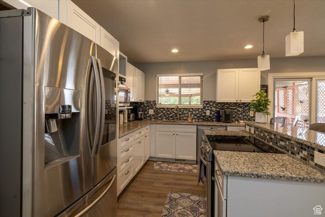 6837 S Baldwin Ave, West Jordan, UT 84084 - kitchen with appliances with stainless steel finishes, decorative backsplash, a sink, light stone counters, and recessed lighting