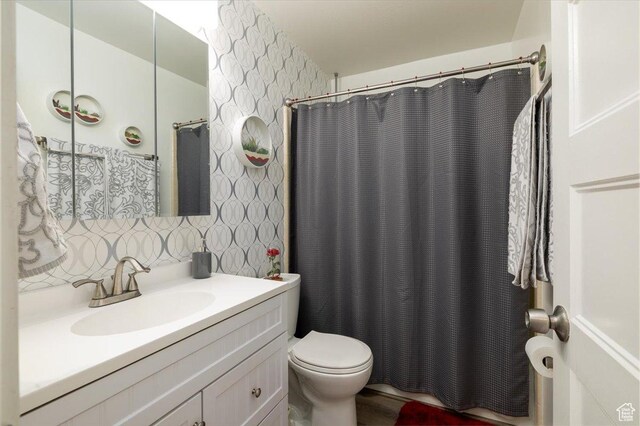 6837 S Baldwin Ave, West Jordan, UT 84084 - full bathroom with vanity, toilet, curtained shower, wallpapered walls, and tasteful backsplash