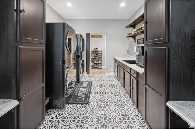 2609 W 3075 S, West Haven, UT 84401 - laundry area with stacked washer / drying machine, light tile patterned floors, recessed lighting, and baseboards