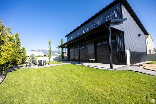 2609 W 3075 S, West Haven, UT 84401 - back of house featuring a patio, an attached garage, and a mountain view
