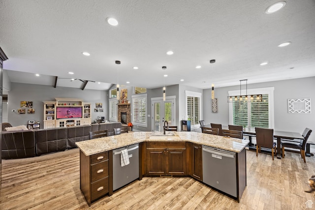 2609 W 3075 S, West Haven, UT 84401 - kitchen featuring dishwasher, open floor plan, a sink, a stone fireplace, and recessed lighting