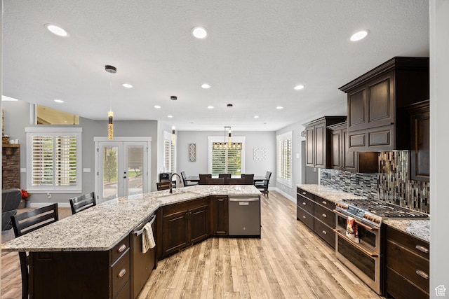 2609 W 3075 S, West Haven, UT 84401 - kitchen featuring stainless steel appliances, light wood-type flooring, a sink, backsplash, and dark brown cabinets