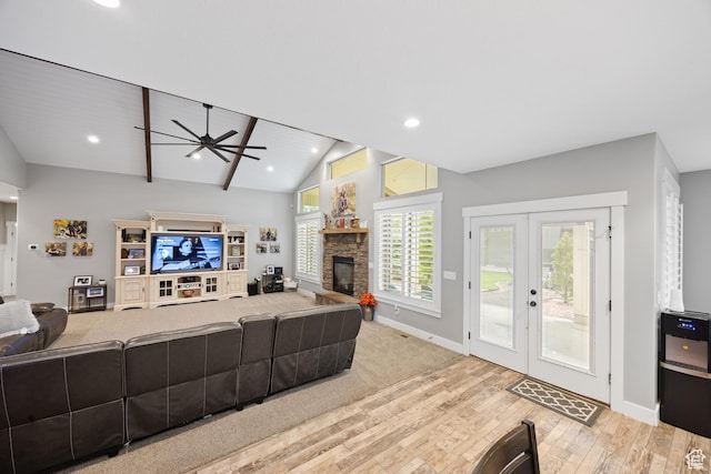 2609 W 3075 S, West Haven, UT 84401 - living room with wood finished floors, a ceiling fan, baseboards, a stone fireplace, and lofted ceiling