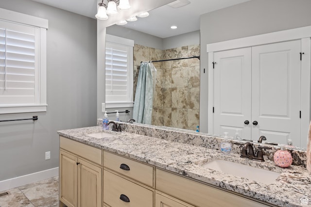 2609 W 3075 S, West Haven, UT 84401 - bathroom featuring double vanity, baseboards, and a tile shower