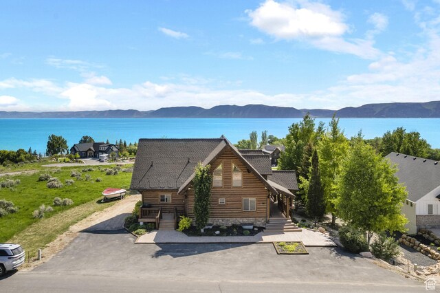 125 W Persimmon Dr Unit 2, Garden City, UT 84028 - view of front of home with a water and mountain view, a shingled roof, and driveway