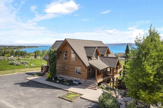 125 W Persimmon Dr Unit 2, Garden City, UT 84028 - log-style house featuring a water view, a shingled roof, and stairs