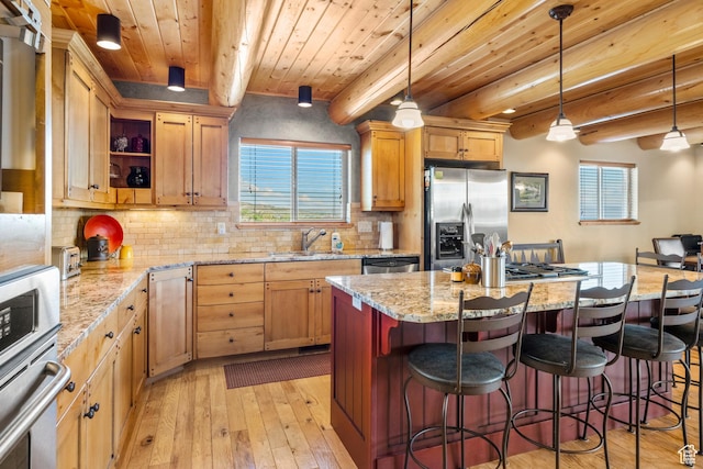 125 W Persimmon Dr Unit 2, Garden City, UT 84028 - kitchen with appliances with stainless steel finishes, a sink, light wood-style floors, plenty of natural light, and wooden ceiling with exposed beams