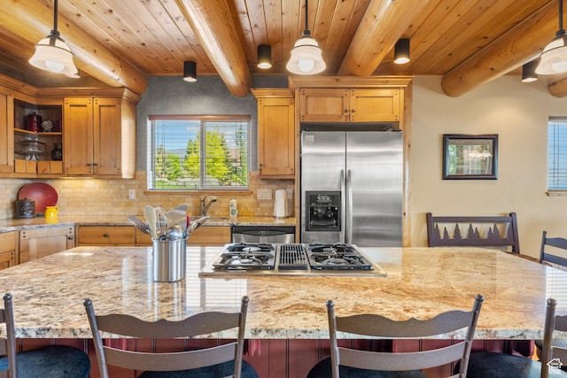 125 W Persimmon Dr Unit 2, Garden City, UT 84028 - kitchen with stainless steel appliances, backsplash, wooden ceiling with exposed beams, light stone countertops, and a breakfast bar area