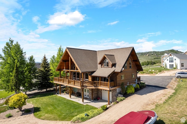 125 W Persimmon Dr Unit 2, Garden City, UT 84028 - back of property with stone siding, a lawn, dirt driveway, log siding, and a shingled roof