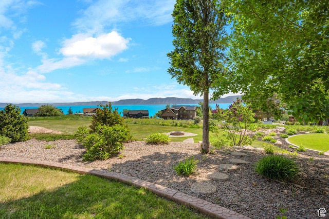 125 W Persimmon Dr Unit 2, Garden City, UT 84028 - view of grassy yard featuring a fire pit and a water and mountain view