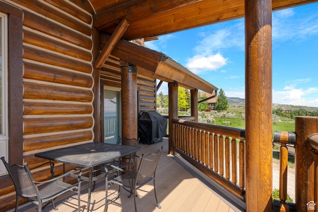 125 W Persimmon Dr Unit 2, Garden City, UT 84028 - wooden terrace featuring area for grilling, a mountain view, and outdoor dining space